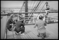Photographers taking pictures of a woman on the S.S. Mariposa, Los Angeles