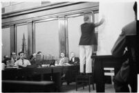 Public defender Ellery Cuff indicating a point on a map at his client Albert Dyer's murder trial, Los Angeles, 1937
