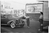 Drive-in waitress carrying a tray, Los Angeles, 1937