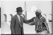 Football coach speaking to a referee on the Coliseum field, Los Angeles, 1937