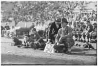 Loyola Lions football coaches watching from the sidelines during a game against the St. Mary's Gaels at the Coliseum, Los Angeles, 1937