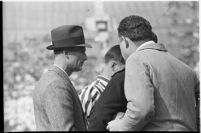 Santa Clara Broncos' head coach Buck Shaw confers with referees during game, Los Angeles, 1937