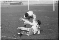 Fallen Loyola Lions player assisted by team mate, 1937.