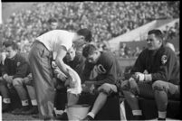 Santa Clara Broncos players on the sidelines, during game against Loyola Lions, 1937