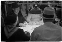Patrons playing cards in a casino, Los Angeles, 1937