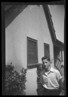 Ewin J. Morford Jr. standing outdoors next to a house, Los Angeles