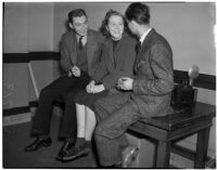 Robert Lange, his sister Ruth Lange and Werner Kawert sitting on a table in the press room, Los Angeles, 1940