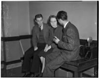 Robert Lange, his sister Ruth Lange and Werner Kawert sitting on a table in the press room, Los Angeles, 1940