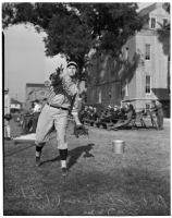 Bob Winslow, pitcher for the USC Trojans baseball team, warming up his arm on the sidelines, Los Angeles, 1940