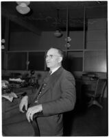 Physical oceanographer Dr. George McEwan of Scripps Institute of Oceanography sits at desk, Los Angeles, 1930