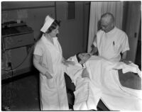 Nurses Tillie Wilson and Bill Pearce attending to patient Joe Infausto, Los Angeles