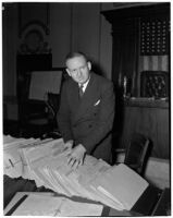 Dixwell L. Pierce sorts folders in a courtroom, Los Angeles, 1940