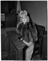 Mae West sitting in court during questioning about earnings from her role in the movie "She Done Him Wrong," Los Angeles, 1940