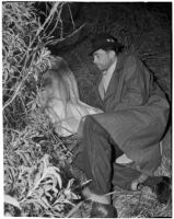 Harlan Bunker next to the body of his 11-year-old murdered daughter, Los Angeles, 1940