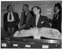 Betty Flay Hardaker stands at a counter in the Los Angeles County Jail after being taken into custody, Los Angeles, 1940