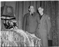 Montebello Chief of Police Maxwell comforts Samuel Karnes, Sr. at the funeral of his granddaugther Geraldine Hardaker, Los Angeles, 1940