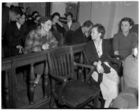 Betty Hardaker, mother convicted of murdering her daughter, speaks to an unidentified woman in a courtroom, Los Angeles, 1940