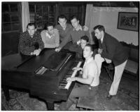 USC Kappa Alpha members sing by a piano inside their fraternity house, Los Angeles, 1940