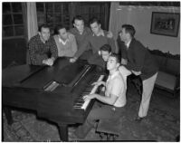 USC Kappa Alpha members sing by a piano inside their fraternity house, Los Angeles, 1940