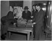 Detective Lieutenants R.S. Hamilton, E.J. Henry, and E.C. Biffle with suspect Adolfo Campos and a suitcase full of smuggled marijuana, Los Angeles