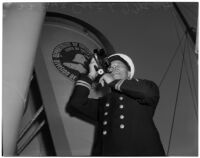 Captain Lars H. Weseth looking through a sextant, Los Angeles, May 23, 1940