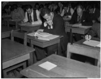Candidates for police and deputy sheriff positions taking a written examination in City Hall, Los Angeles, March 2, 1940