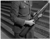 Soldier holding the U.S. Army's new Garand rifle, on display as part of National Defense week, Los Angeles, February 1940