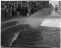 Burst fire hydrant flooding 1st and Main St. in downtown Los Angeles, circa 1940