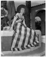 Mrs. Priestly A. Horton sitting on the base of a statue, Los Angeles, circa 1940