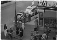 Aerial view of pedestrians and Owl Drug on the corner of Hollywood and Vine, Los Angeles, 1940