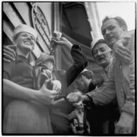 Group celebrates Japan's surrender during World War II on Main Street in downtown Los Angeles, August 15 and 16, 1945