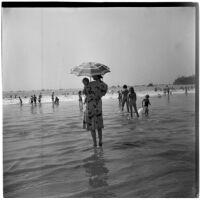 Woman with baby at the beach Labor Day, Los Angeles, September 3, 1945