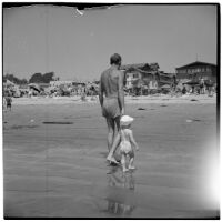 Father and child at the beach on Labor Day, Los Angeles, September 3, 1945