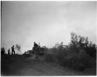 Man uses a small bulldozer to clear brush after a fire in La Canada, Los Angeles, October 1945