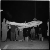 Lockheed employees and members of the International Association of Machinists prepare a model aircraft to be used on a float in the Tournament of Roses Parade, Pasadena, 1946