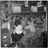 Veterans filling out paperwork to purchase Quonset huts and other surplus military supplies, Port Hueneme, July 15, 1946