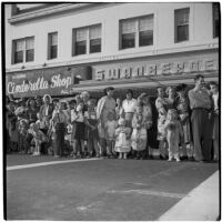 Spectators standing on the side of the street and enjoying the post-war Labor Day parade, Los Angeles, 1946