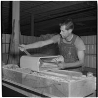 Employee works on a ceramic toilet tank at the Universal Vitreous China Factory, Mentone, circa 1948