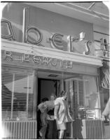 Women evacuating Staber's Beauty Salon because of a fire at the nearby Melody Lane Café, Los Angeles, 1947