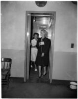 Louise Henderson Carringer walks into jail after police officers find her seven-year-old daughter, Linda Carringer, asleep alone in a car, Los Angeles, 1947