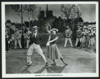 Gene Kelly, Leslie Caron, and other cast members in An American in Paris