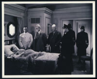 John Voigt, Lionel Royce, and other cast members in a scene from Confessions of a Nazi Spy