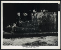 Henry Kulky, Ashley Cowan, Cameron Mitchell and cast members atop a submarine in Hell and High Water