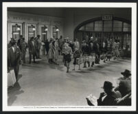 Marjorie Main leading her family through a railroad station in a scene from The Kettles in the Ozarks