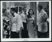 Alan Ladd, Wally Cassell and extras in a scene from Saigon