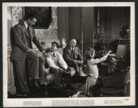 Robert Young, Dudley Digges, Mickey Kuhn and Ann Carter in a scene from The Searching Wind