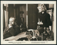 Lloyd Corrigan and Anita Louise in a scene from Shadowed