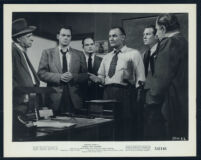 Emile Meyer, John Agar and other cast members in a scene from Shield For Murder