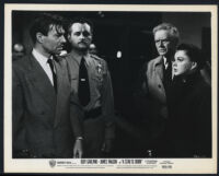 Judy Garland, James Mason, Charles Bickford, and extras in A Star Is Born