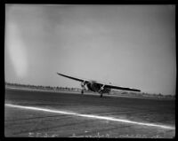 Airplane lifting off the ground at the National Air Races, Los Angeles, 1936